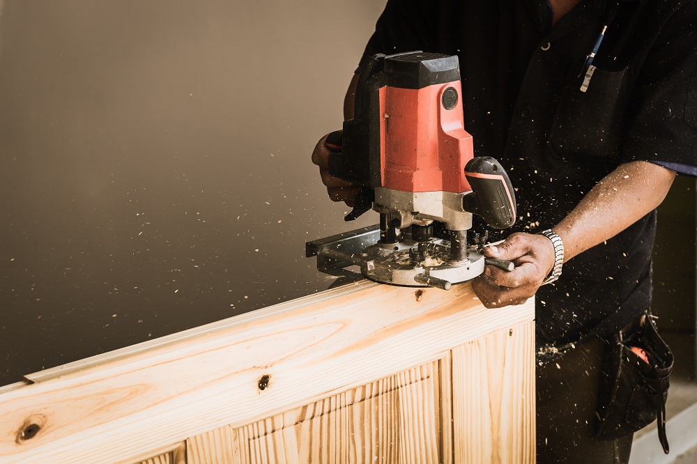 carpenter using a wood router