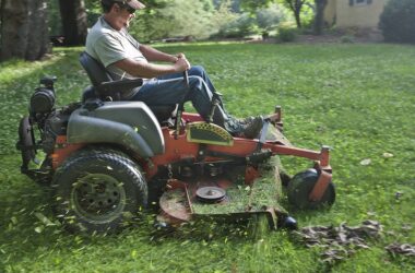 landscaper using a riding lawnmower